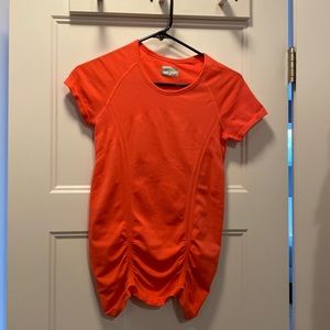 Athleta orange stretch shirt with some bunching at the bottom. Size XS